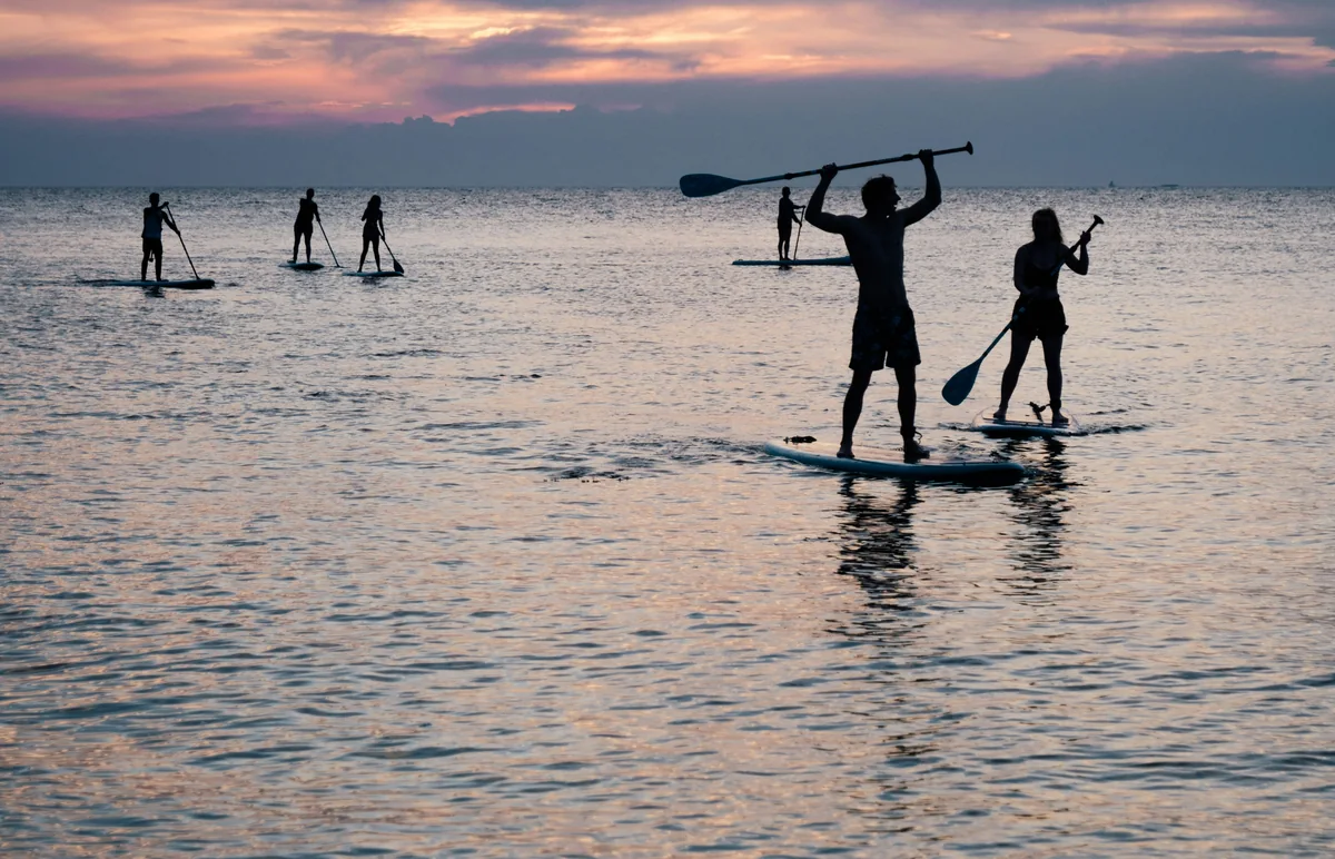 Group paddle boarding on a calm sea